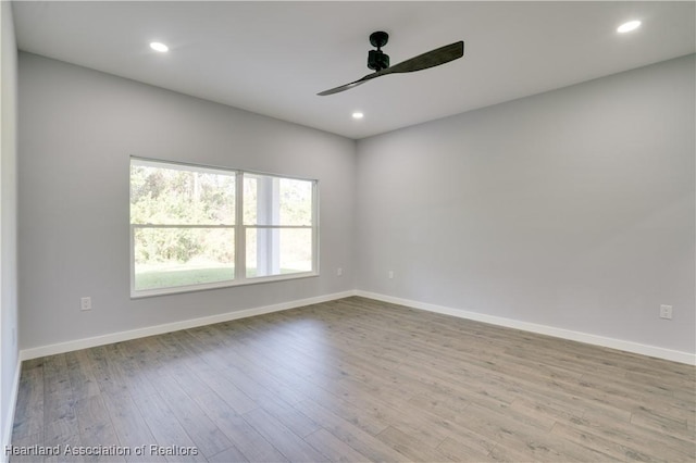 unfurnished room with light wood-type flooring and ceiling fan