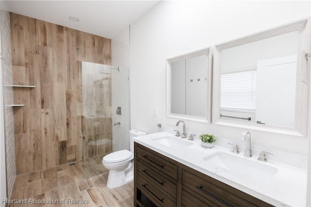 bathroom featuring tiled shower, vanity, and toilet