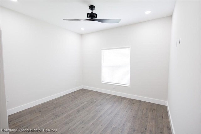 empty room featuring ceiling fan and hardwood / wood-style floors