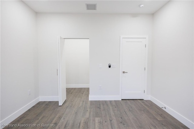 unfurnished room with hardwood / wood-style flooring