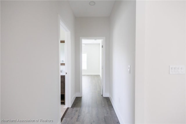 corridor with light hardwood / wood-style floors