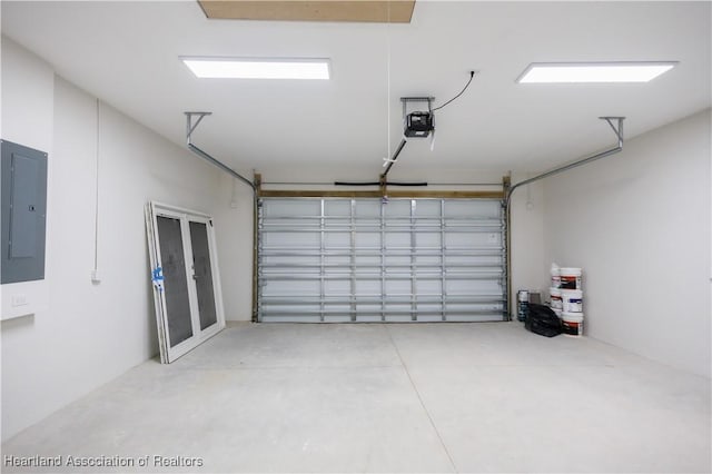 garage with electric panel and a garage door opener