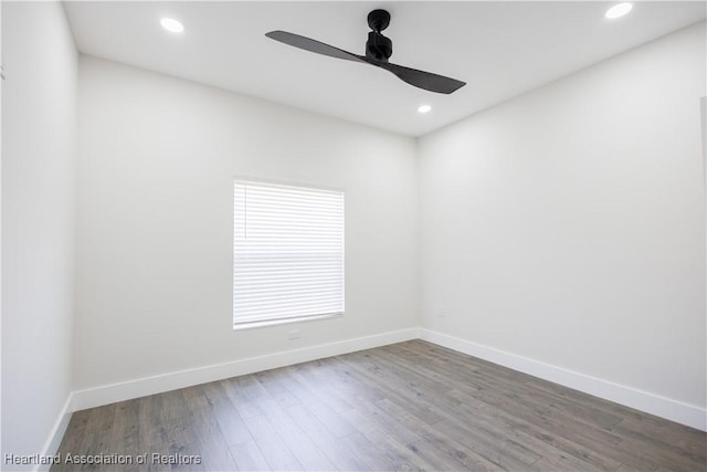 empty room with ceiling fan and wood-type flooring