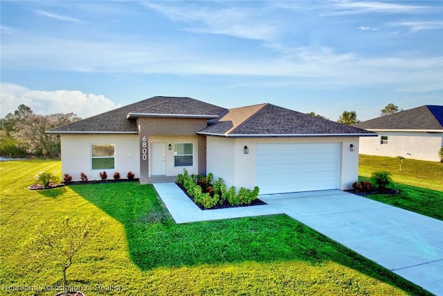 view of front of property with a front lawn and a garage