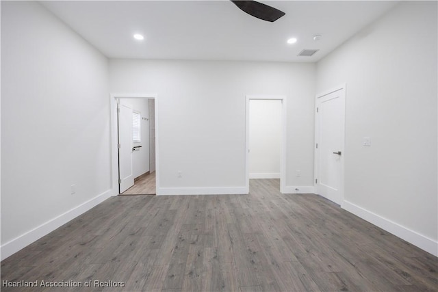 empty room with ceiling fan and hardwood / wood-style floors