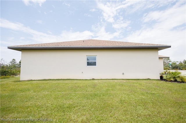 view of side of property with a lawn