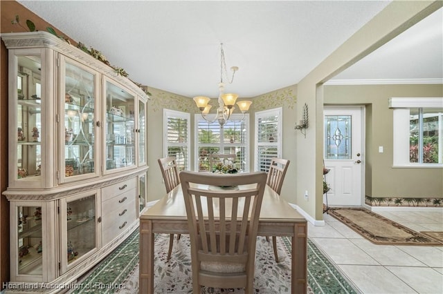 dining area featuring a chandelier, light tile patterned floors, crown molding, and a healthy amount of sunlight