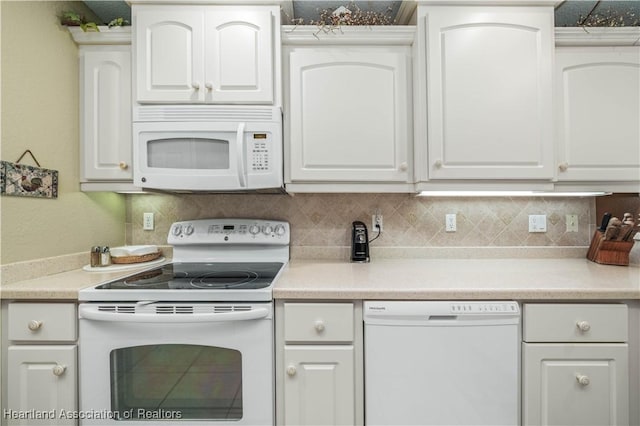 kitchen with tasteful backsplash, white cabinetry, and white appliances