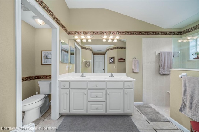 bathroom featuring tile patterned floors, vanity, tiled shower, and toilet