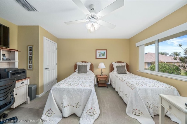 bedroom featuring ceiling fan and light carpet