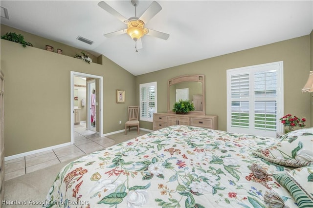 tiled bedroom featuring connected bathroom, ceiling fan, and lofted ceiling