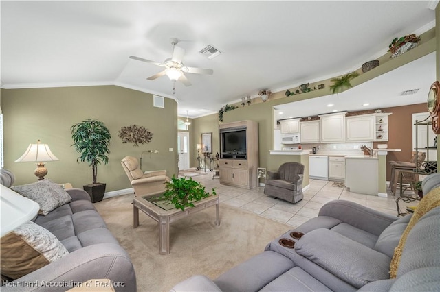 living room with light tile patterned floors, vaulted ceiling, ceiling fan, and ornamental molding