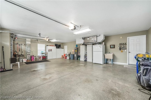 garage with sink, water heater, white fridge, electric panel, and a garage door opener