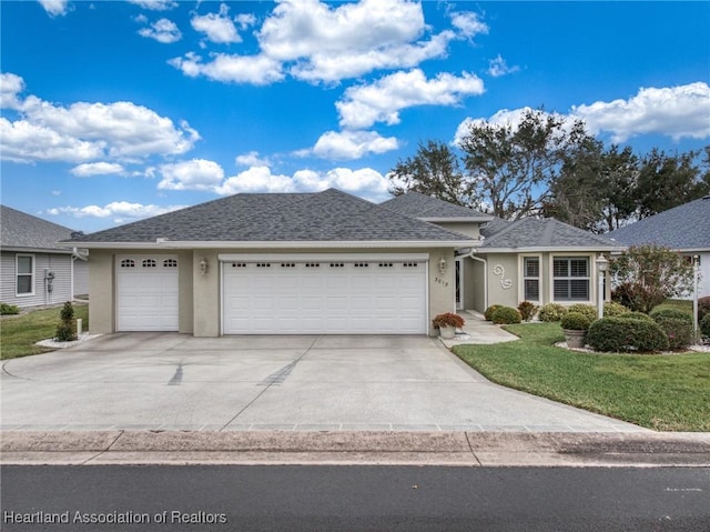 ranch-style home featuring a garage and a front lawn