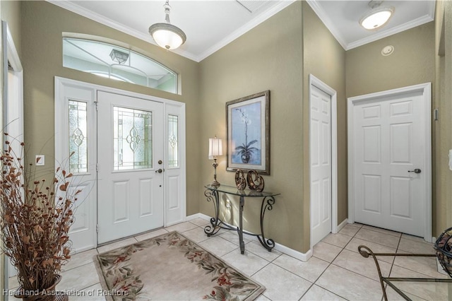 entrance foyer featuring light tile patterned flooring and ornamental molding