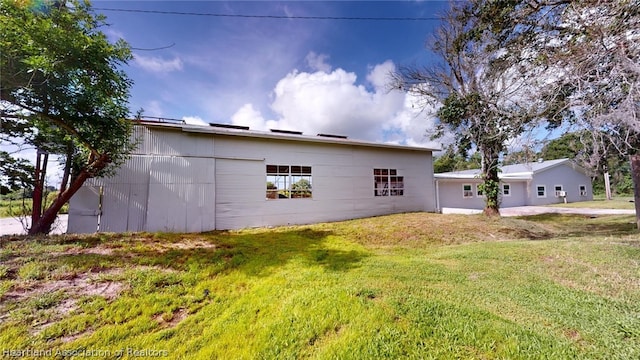 back of house with a lawn