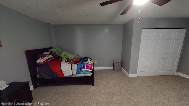 carpeted bedroom featuring a closet and ceiling fan