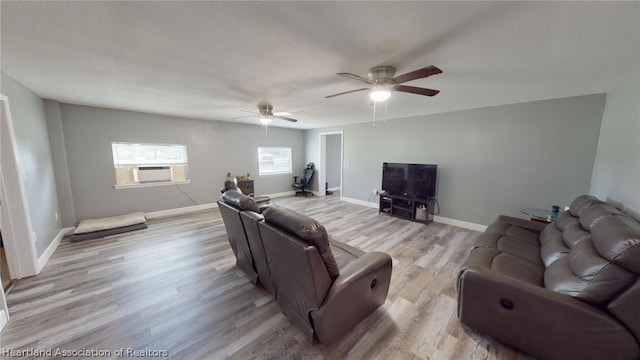 living room with light hardwood / wood-style floors and ceiling fan