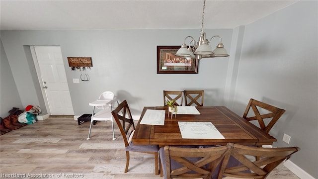 dining room featuring light hardwood / wood-style floors and a notable chandelier