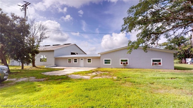 back of house with a patio area and a lawn