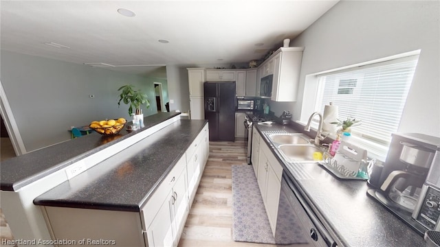 kitchen with light hardwood / wood-style floors, sink, white cabinets, and black appliances