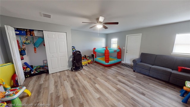 game room with ceiling fan and light hardwood / wood-style flooring