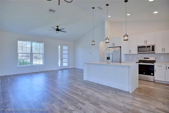 kitchen featuring light wood-type flooring, visible vents, appliances with stainless steel finishes, and a center island