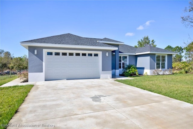 view of front facade featuring roof with shingles, stucco siding, concrete driveway, a front yard, and a garage