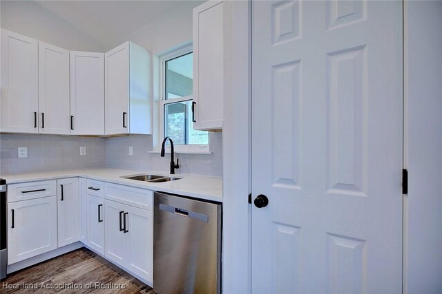 kitchen with dishwasher, a sink, white cabinetry, and decorative backsplash