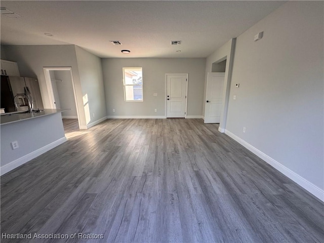 unfurnished living room featuring hardwood / wood-style flooring