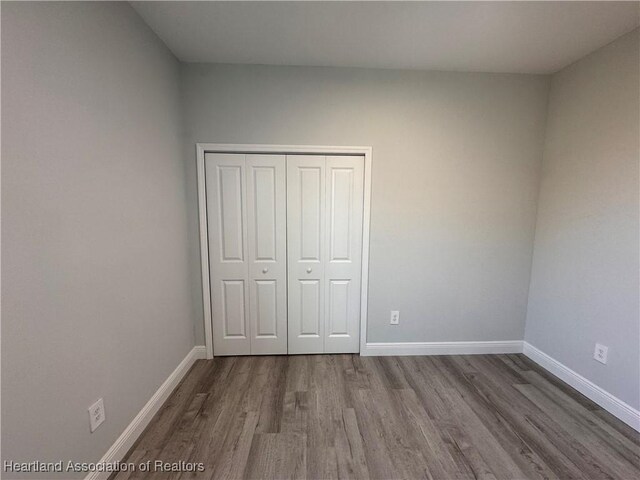 1940 Alan St, Sebring, FL 33875 - unfurnished bedroom featuring hardwood / wood-style flooring and a closet