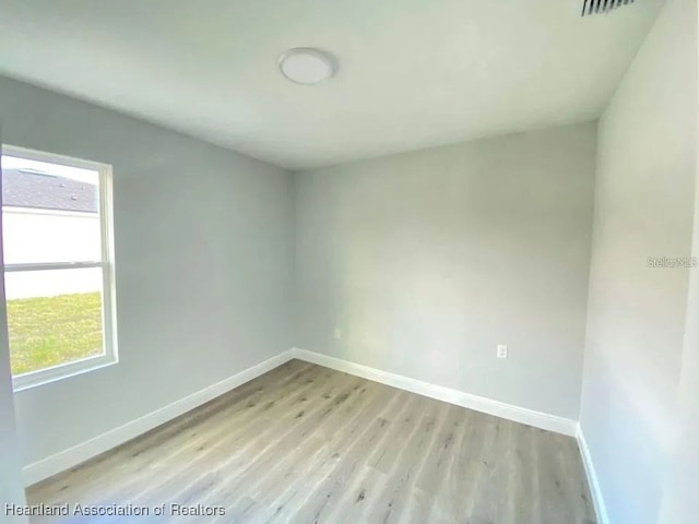 unfurnished room featuring a healthy amount of sunlight and light hardwood / wood-style floors