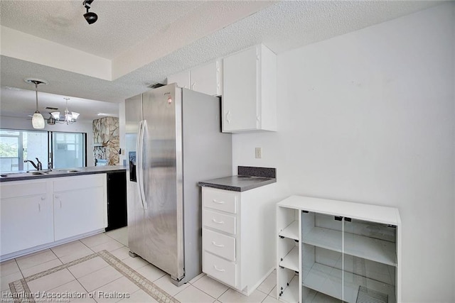 4524 Lafayette Ave, Sebring, FL 33875 - kitchen featuring a sink, stainless steel refrigerator with ice dispenser, light tile patterned floors, a textured ceiling, and white cabinetry