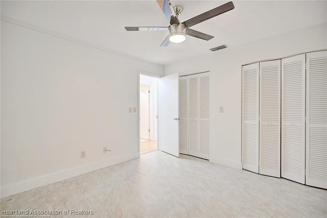 4524 Lafayette Ave, Sebring, FL 33875 - unfurnished bedroom featuring two closets, baseboards, and ceiling fan