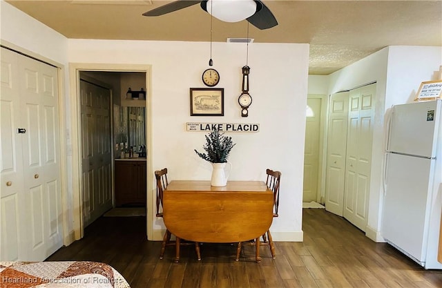 dining area with visible vents, wood finished floors, and ceiling fan