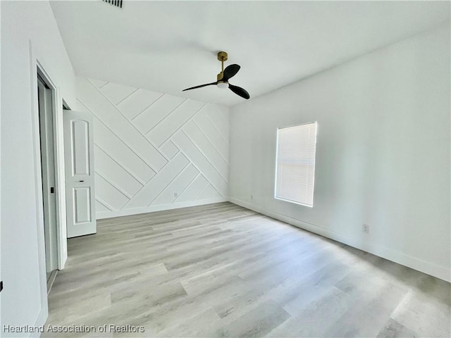 unfurnished room featuring ceiling fan and light wood-type flooring