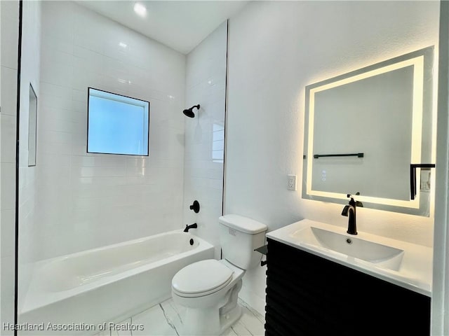 full bathroom featuring tiled shower / bath combo, toilet, and vanity