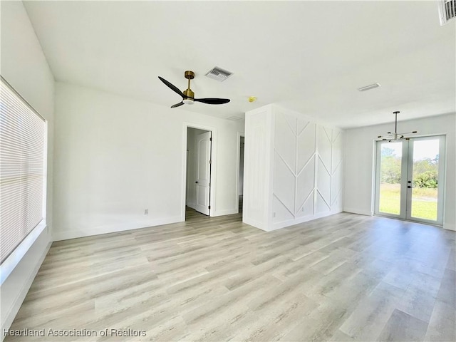 spare room with french doors, light hardwood / wood-style floors, and ceiling fan