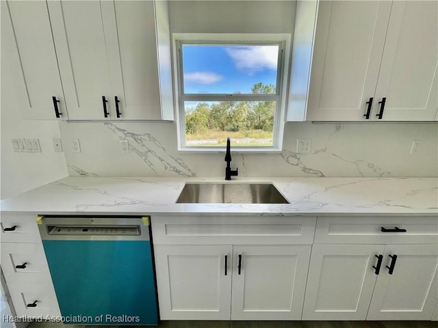 kitchen with dishwasher, backsplash, white cabinetry, and sink