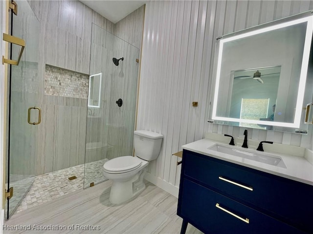 bathroom with vanity, an enclosed shower, and toilet