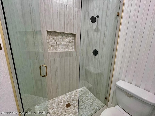 bathroom with toilet and walk in shower