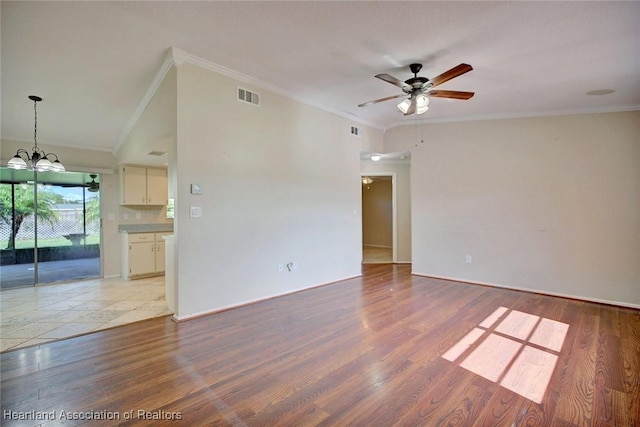 unfurnished room with ceiling fan with notable chandelier, light hardwood / wood-style floors, and ornamental molding