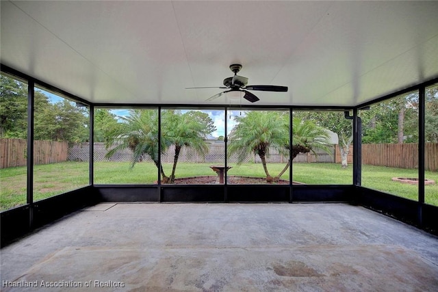 unfurnished sunroom featuring ceiling fan