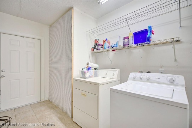 washroom featuring separate washer and dryer and light tile patterned floors