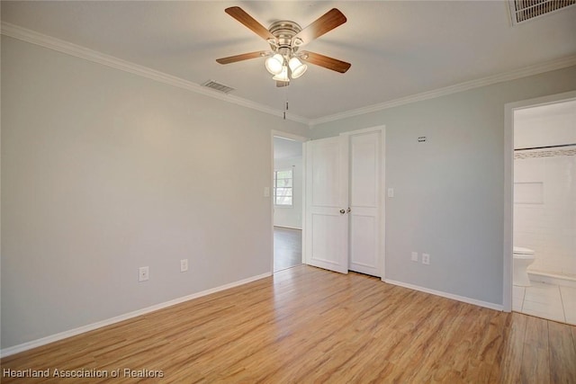 unfurnished bedroom featuring ceiling fan, light hardwood / wood-style floors, ornamental molding, and ensuite bathroom