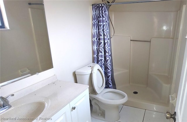 bathroom with toilet, a shower stall, tile patterned flooring, and vanity