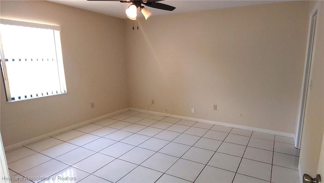 empty room featuring plenty of natural light, baseboards, and a ceiling fan