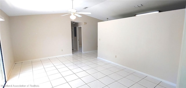 spare room featuring ceiling fan, light tile patterned flooring, lofted ceiling, and visible vents