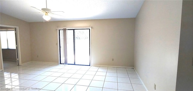 spare room featuring light tile patterned floors, ceiling fan, and baseboards