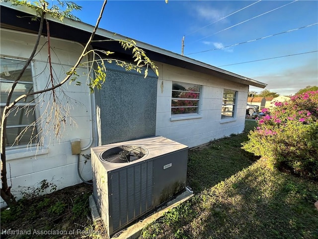 view of side of home featuring central AC